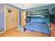 Bright bedroom featuring a bunk bed, hardwood floors and closet at 3658 Brock Rd, Duluth, GA 30096