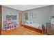 Cozy bedroom featuring hardwood floors, natural light and a fun dollhouse display at 3658 Brock Rd, Duluth, GA 30096