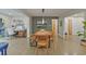Open-concept dining area featuring hardwood floors, custom wall art, and adjacent living spaces at 3658 Brock Rd, Duluth, GA 30096