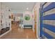Bright foyer featuring hardwood floors, modern lighting, and a stylish blue front door at 3658 Brock Rd, Duluth, GA 30096