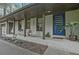 Charming front porch featuring modern blue door, swing chairs, and inviting curb appeal at 3658 Brock Rd, Duluth, GA 30096