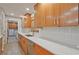 The kitchen has wood cabinets, light countertops, tile backsplash, and stainless steel appliances at 3658 Brock Rd, Duluth, GA 30096