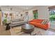 Bright living room with neutral walls, colorful couches, natural light from windows, and decorative shelving at 3658 Brock Rd, Duluth, GA 30096