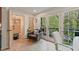 Bright living area with French doors, a comfortable chair, and views of lush greenery outside at 3658 Brock Rd, Duluth, GA 30096
