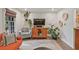 Cozy living room with a comfortable chair, TV, plants, and view of the backyard through a large window at 3658 Brock Rd, Duluth, GA 30096