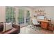 Bright office space with a desk, shelving, and sliding doors leading to the outdoor balcony at 3658 Brock Rd, Duluth, GA 30096