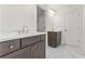 Well-lit bathroom featuring double vanity with modern fixtures, marble floors, and linen closet at 668 Crest Line Trl, Powder Springs, GA 30127