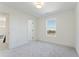Neutral bedroom with plush carpet, a window, and an adjacent doorway for easy access at 668 Crest Line Trl, Powder Springs, GA 30127