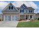 Inviting two-story home featuring a brick and siding exterior, attached two-car garage, and well-manicured lawn at 668 Crest Line Trl, Powder Springs, GA 30127