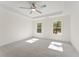 Sunlit bedroom with a ceiling fan, tray ceiling and soft carpeting at 699 Crest Line W Trl, Powder Springs, GA 30127