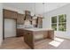 Modern kitchen featuring a center island, designer cabinets, stainless steel appliances, and a decorative tile backsplash at 699 Crest Line W Trl, Powder Springs, GA 30127