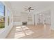 Spacious living room featuring a decorative fireplace, custom built-ins, light hardwood floors, and ample natural light at 699 Crest Line W Trl, Powder Springs, GA 30127