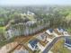 Stunning aerial view of homes near a lake surrounded by lush trees and a winding neighborhood street at 1395 Crestwind Nw Rd, Kennesaw, GA 30152