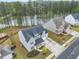Aerial view of home near pond surrounded by mature trees and a lush green lawn at 1395 Crestwind Nw Rd, Kennesaw, GA 30152
