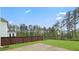 Fenced backyard with a patio surrounded by large, mature trees at 1395 Crestwind Nw Rd, Kennesaw, GA 30152