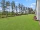 Lush backyard featuring a fence, mature trees, and a home with siding at 1395 Crestwind Nw Rd, Kennesaw, GA 30152