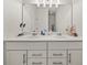 Bright bathroom featuring a double sink vanity with chrome fixtures and ample storage at 1395 Crestwind Nw Rd, Kennesaw, GA 30152