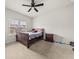 Bedroom featuring ceiling fan, carpet, bed and nightstand at 1395 Crestwind Nw Rd, Kennesaw, GA 30152