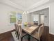 Bright dining room featuring tray ceilings, a large window, and a modern table with seating for six at 1395 Crestwind Nw Rd, Kennesaw, GA 30152