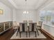 Bright dining room featuring tray ceilings, a large window, and a modern table with seating for six at 1395 Crestwind Nw Rd, Kennesaw, GA 30152