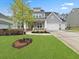 Charming two-story home features a manicured lawn and a two-car garage with a gray color scheme at 1395 Crestwind Nw Rd, Kennesaw, GA 30152