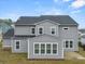 A view of the back of the house, including the roof, siding, windows and an outdoor living space at 1395 Crestwind Nw Rd, Kennesaw, GA 30152