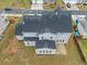 A high aerial angle showing the rear of the house, roof, yard and patio at 1395 Crestwind Nw Rd, Kennesaw, GA 30152