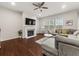 Bright living room with fireplace, ceiling fan, hardwood floors and comfortable seating at 1395 Crestwind Nw Rd, Kennesaw, GA 30152