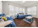 Cozy living room with blue couches and lots of natural light at 1395 Crestwind Nw Rd, Kennesaw, GA 30152