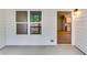 The back porch features a window, light fixture, and is right off the kitchen, creating a comfortable space for outdoor relaxation at 3908 Shelleydale Dr, Powder Springs, GA 30127