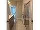 Modern bathroom featuring double vanity with shower and tub behind glass doors at 3908 Shelleydale Dr, Powder Springs, GA 30127