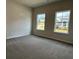 Bedroom with neutral carpet, and two windows looking out to neighborhood at 3908 Shelleydale Dr, Powder Springs, GA 30127