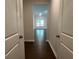 Hallway view showing hardwood floors leading to a room with large windows at 3908 Shelleydale Dr, Powder Springs, GA 30127