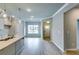 Open-concept living space featuring light hardwood floors, neutral paint, and modern lighting fixtures, perfect for entertaining at 3908 Shelleydale Dr, Powder Springs, GA 30127