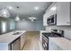 Contemporary kitchen with a central island, stainless steel appliances, and an open layout offers a modern cooking space at 3908 Shelleydale Dr, Powder Springs, GA 30127