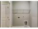 This laundry room has a white storage rack and convenient hookups, creating a functional and organized space at 3908 Shelleydale Dr, Powder Springs, GA 30127