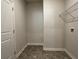 Small laundry room with vinyl flooring, wire shelving, and a washer/dryer hookups at 3908 Shelleydale Dr, Powder Springs, GA 30127