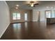 Open-concept living area featuring hardwood floors and recessed lighting and kitchen in the background at 3908 Shelleydale Dr, Powder Springs, GA 30127
