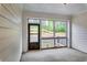 This screened porch has white wood planks, views of the landscape, and natural lighting for an enjoyable indoor-outdoor space at 3908 Shelleydale Dr, Powder Springs, GA 30127