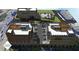 An aerial view showcasing the multi-building development with parking, street access, and patio areas at 120 N Main St # 2A, Alpharetta, GA 30009