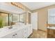 Bright bathroom featuring a bathtub, shower and double sink vanity with tile flooring at 1455 Oglethorpe Run Ln, Suwanee, GA 30024