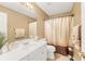 Bathroom features a vanity, toilet and shower with modern fixtures and neutral finishes at 1455 Oglethorpe Run Ln, Suwanee, GA 30024