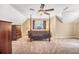 Bedroom with carpet, vaulted ceiling, four-poster bed and a large window overlooking the backyard at 1455 Oglethorpe Run Ln, Suwanee, GA 30024