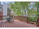 Spacious backyard deck featuring patio table and seating overlooking lush green landscape at 1455 Oglethorpe Run Ln, Suwanee, GA 30024