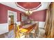 Elegant dining room featuring a tray ceiling, chandelier, and classic furnishings at 1455 Oglethorpe Run Ln, Suwanee, GA 30024