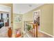 Foyer and staircase showcasing wrought iron spindles and a decorative chandelier at 1455 Oglethorpe Run Ln, Suwanee, GA 30024