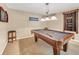 This carpeted game room features a pool table with an ornate light fixture at 1455 Oglethorpe Run Ln, Suwanee, GA 30024
