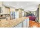Open kitchen featuring granite countertops, stainless steel appliances, and breakfast bar overlooking the living area at 1455 Oglethorpe Run Ln, Suwanee, GA 30024