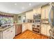 Modern kitchen with stainless steel appliances, granite countertops, and custom cabinetry at 1455 Oglethorpe Run Ln, Suwanee, GA 30024