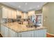 Well-lit kitchen featuring granite countertops, stainless steel appliances, and cream colored cabinets at 1455 Oglethorpe Run Ln, Suwanee, GA 30024